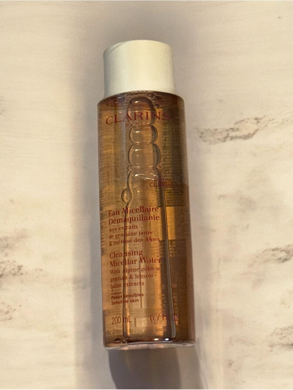Clarins Cleansing Micellar Water — Amber Liquid, White Cap